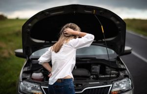 A person checking out an engine issue with their car near Anderson, Indiana