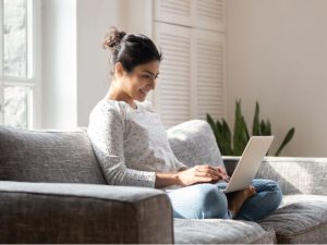A person sitting on their couch at home browsing for details on the 2024 Chevrolet Silverado 1500
