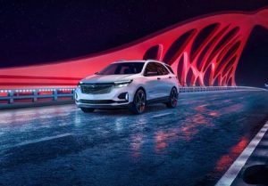 A white 2024 Chevrolet Equinox driving across a bridge near Anderson, Indian
