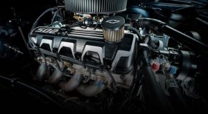 Chevrolet crate engine close-up showcasing valve covers, air filter, and exhaust headers — high-performance Chevy engine for muscle cars and custom builds.