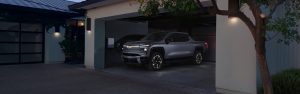 Chevrolet pickup truck parked in a modern home garage at dusk.