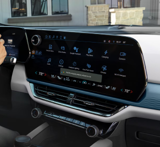 A wide Chevrolet center touchscreen showing app icons above the climate controls