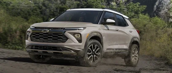 2026 Chevrolet Trailblazer driving on a dirt road, front three-quarter view