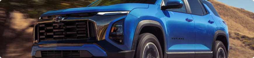 Close-up of the front of a blue 2027 Chevrolet Equinox on a hillside track