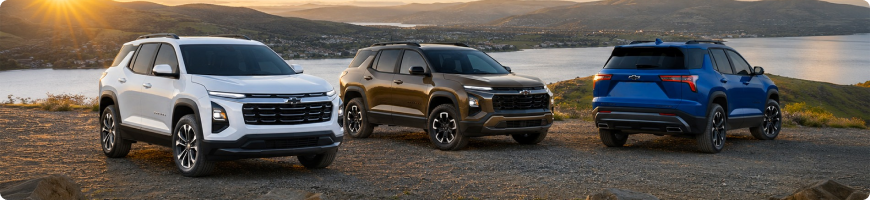 White, brown and blue 2027 Chevrolet Equinox models parked together overlooking a lake at sunset